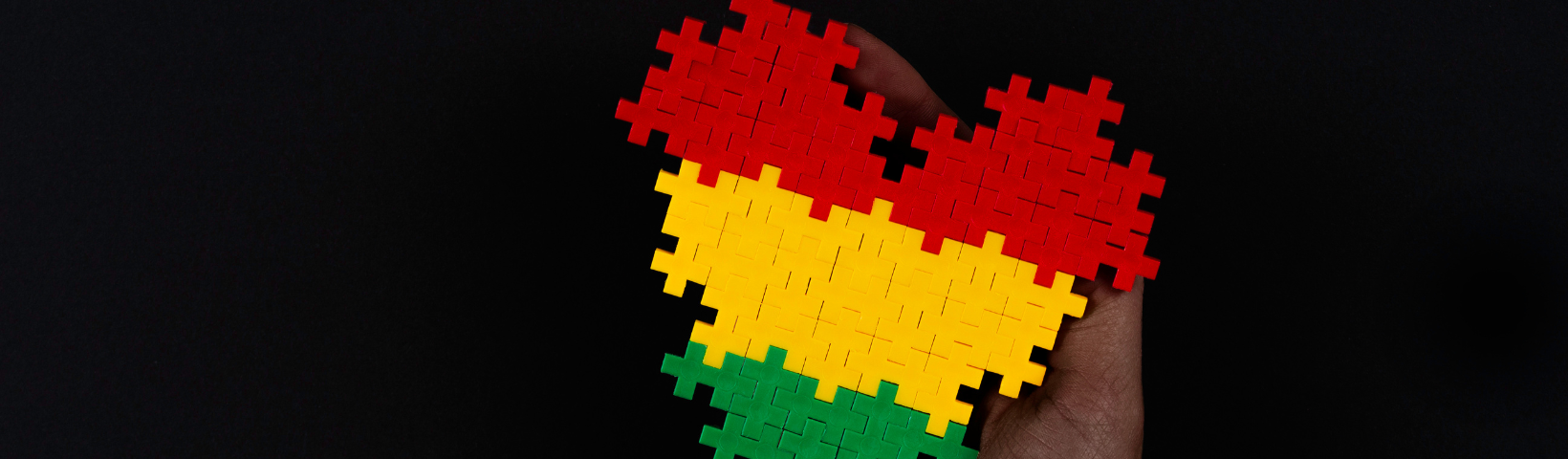 Lego Heart in red, yellow and green on black screen