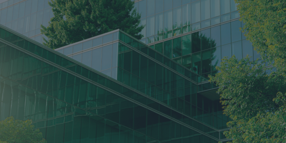 Buildings surrounded by green trees